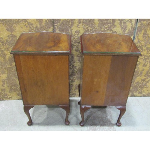 1122 - A pair of reproduction Georgian style bedside/lamp tables, the serpentine front partially enclosed b... 