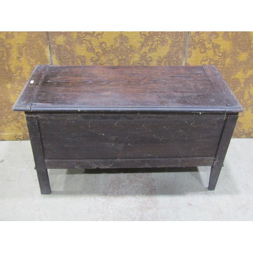 1126 - A dark stained oak blanket box in the Jacobean style with hinged lid over a geometric moulded panell... 