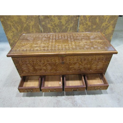 1149 - A chip carved coffer/chest with repeating floral detail, the hinged lid with inset glass top over fo... 