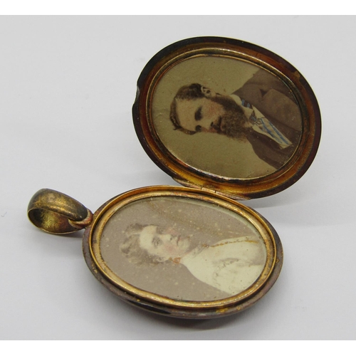 357 - Antique locket with applied monogram, containing photographs of a lady and a gentleman, 15g and a la... 