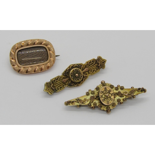 366 - Three antique brooches; a 19th century yellow metal mourning brooch containing woven hair and two ea... 