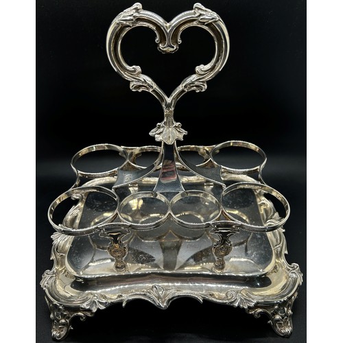 273 - A Victorian silver table condiment stand with eight glass bottles, the oblong scrolled stand is rais... 