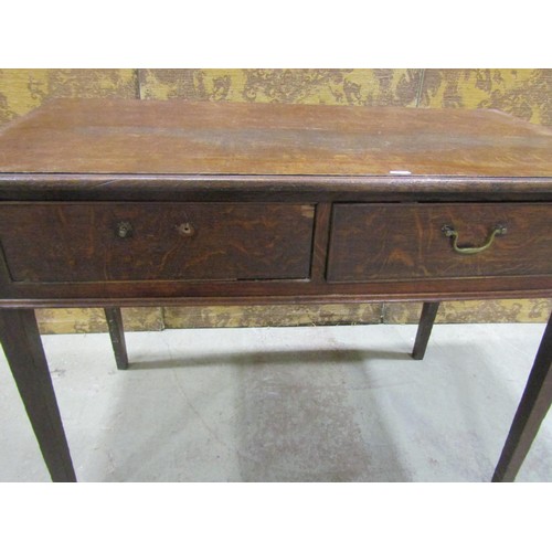 1216 - A Georgian oak side table, the rectangular top with moulded outline over two frieze drawers raised o... 