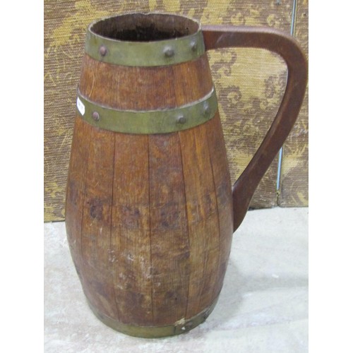 1217 - A vintage coopered oak and brass banded jug with loop handle 41 cm high, a small carved wooden dug o... 