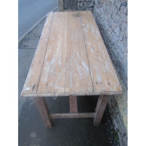 1163 - A rustic pine kitchen table, the rectangular boarded top with split bamboo moulded surround raised o... 