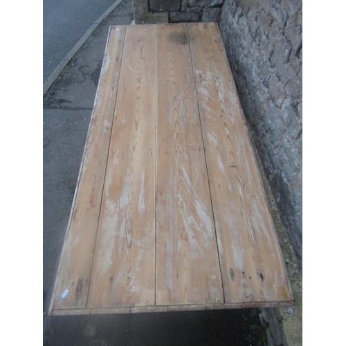 1163 - A rustic pine kitchen table, the rectangular boarded top with split bamboo moulded surround raised o... 