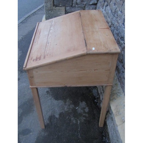 1152 - A stripped pine clerks desk, the hinged sloping lid enclosing a simple pigeon holed interior raised ... 