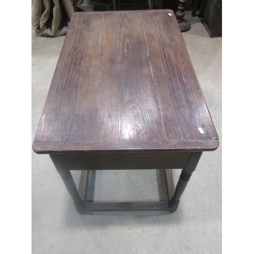 1153 - An antique oak stained pine side table, the plank top with cleated ends over a frieze drawer and tur... 