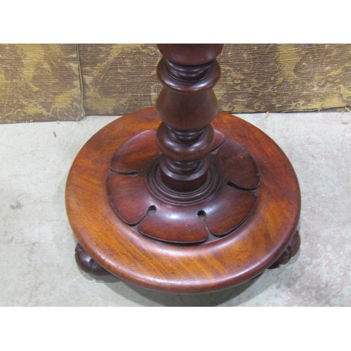 1222 - A Victorian Mahogany snap top occasional table of circular form with moulded outline raised on a tur... 