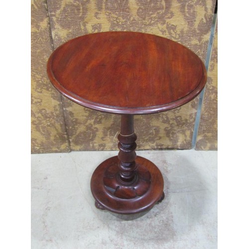 1222 - A Victorian Mahogany snap top occasional table of circular form with moulded outline raised on a tur... 