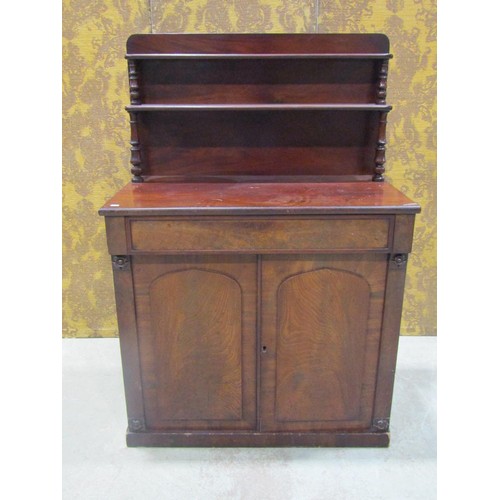 1261 - A 19th century mahogany chiffonier enclosed by a pair of arched panelled doors beneath a frieze draw... 