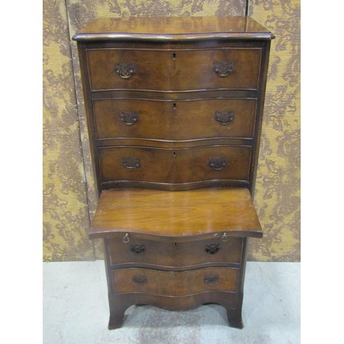 1265 - A figured walnut veneered serpentine front chest in the Georgian style of six long oak lined drawers... 