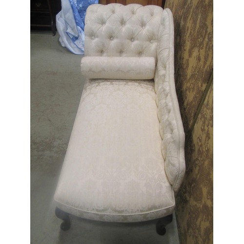 1268 - A small reproduction chaise lounge with upholstered seat and button back raised on cabriole supports... 