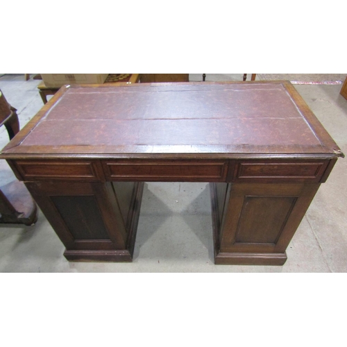 1221 - An oak pedestal desk fitted with six drawers and a cupboard with inset top, 125cm wide