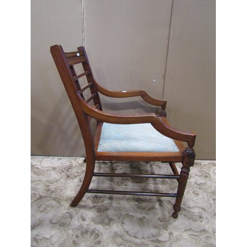 1270 - A late Victorian open elbow chair with upholstered pad seat, moulded frame and turned supports