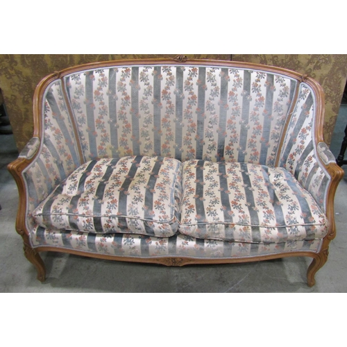 1274 - A French two seater sofa with carved and moulded frame, raised on cabriole supports with floral upho... 