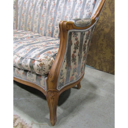 1274 - A French two seater sofa with carved and moulded frame, raised on cabriole supports with floral upho... 