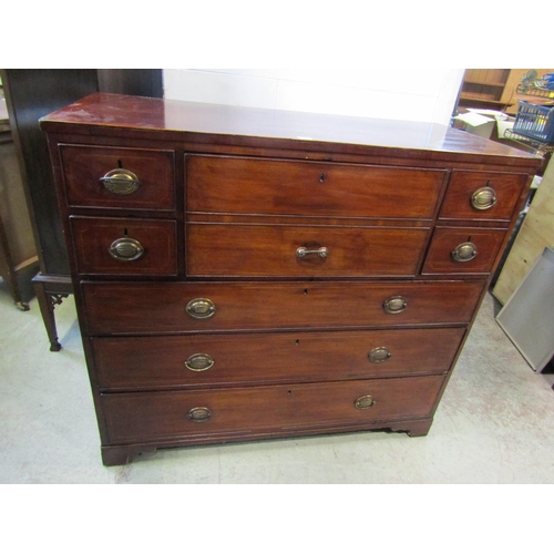 1298 - A 19th century mahogany secretaire chest, the hinged front enclosing a divisional interior, flanked ... 