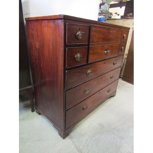 1298 - A 19th century mahogany secretaire chest, the hinged front enclosing a divisional interior, flanked ... 