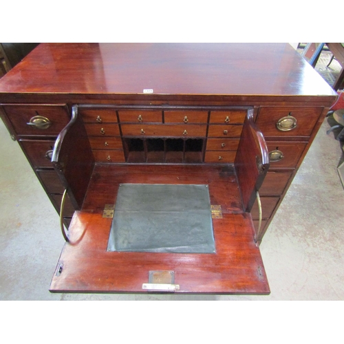 1298 - A 19th century mahogany secretaire chest, the hinged front enclosing a divisional interior, flanked ... 