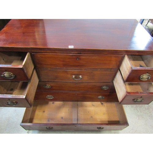 1298 - A 19th century mahogany secretaire chest, the hinged front enclosing a divisional interior, flanked ... 