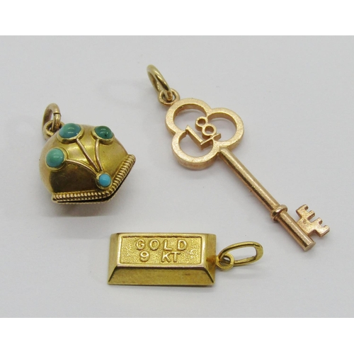 315 - Three small gold charms / pendants comprising a 9k ingot, a 9ct 18th birthday key and a bell set wit... 