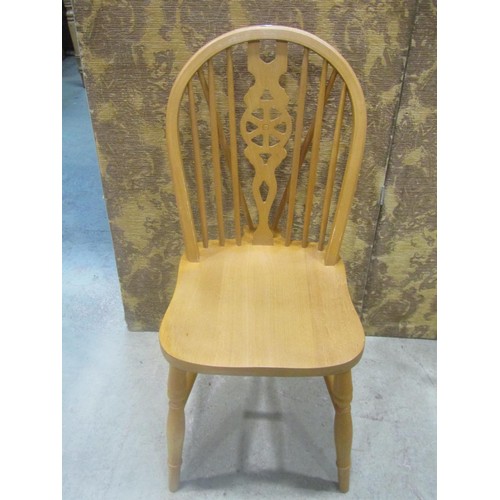 1110 - A set of six modern beech Windsor wheel back dining chairs (4&2)