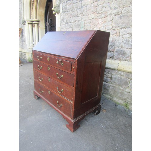 1210 - A Georgian oak bureau country made bureau, the fall flap enclosing a fitted interior over four long ... 