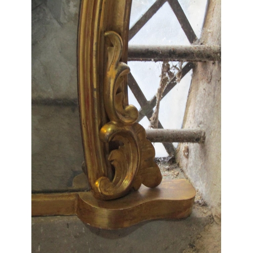 1324 - 19th century gilded overmantle mirror with shaped frame and scrolled detail, 95cm x 130cm