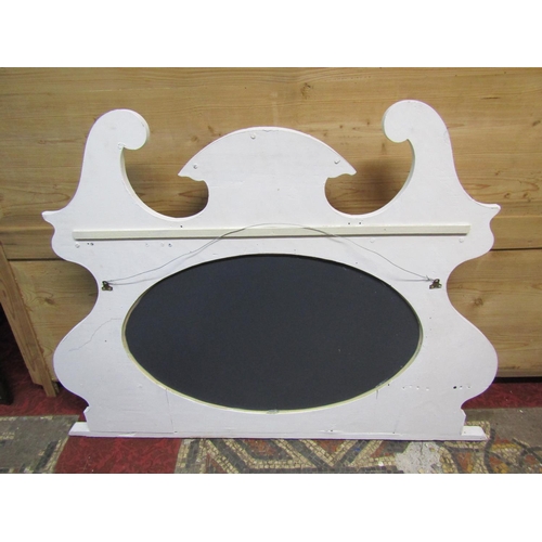 1325 - An Edwardian overmantle mirror with shaped outline and later painted finish