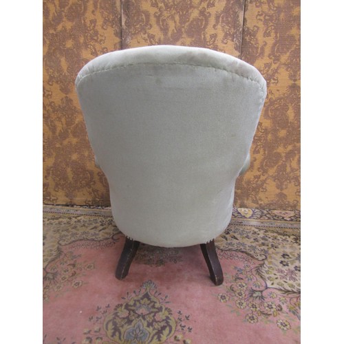 1433 - An Edwardian drawing room chair with later upholstered finish, buttoned back on turned forelegs