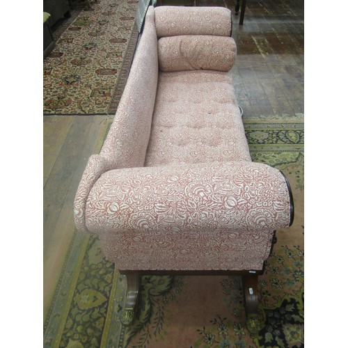 1435 - A Regency mahogany sabre leg settee with carved detail and later upholstered finish, 210cm long