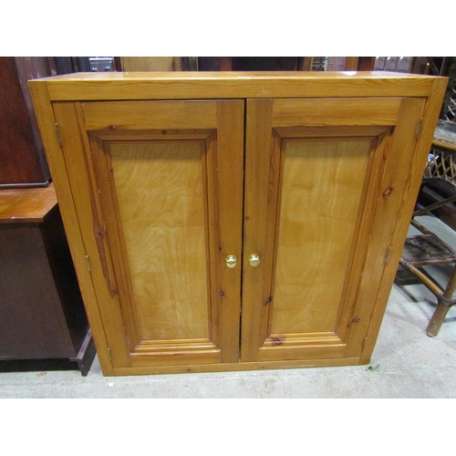 1340 - A pine side cupboard enclosed by a pair of rectangular panelled doors, 102cm wide, 36cm deep, 101cm ... 