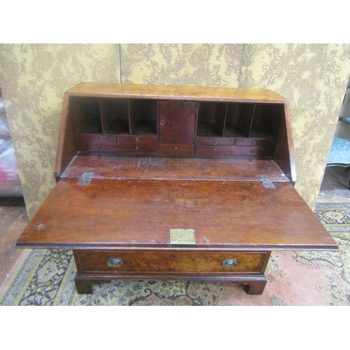 1444 - Georgian yew bureau of four long graduated drawers on bracket supports, the fall flap enclosing a fi... 