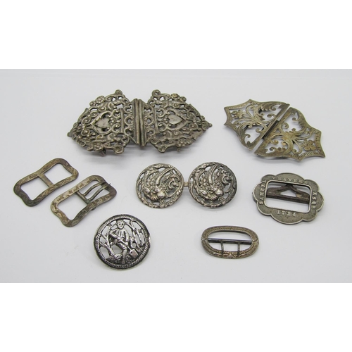 411 - Collection of antique silver buckles and buttons, to include a late Victorian button depicting a gar... 