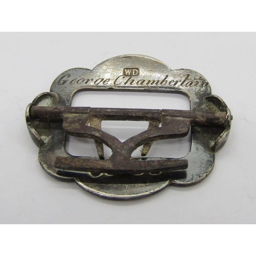 411 - Collection of antique silver buckles and buttons, to include a late Victorian button depicting a gar... 