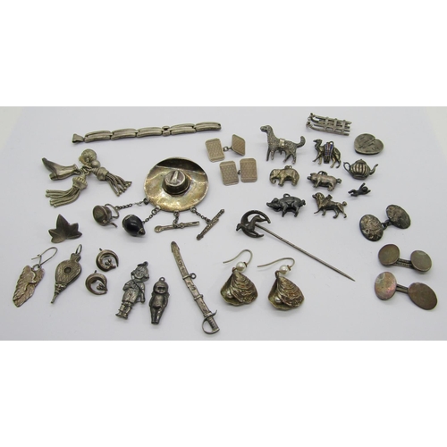 413 - Mixed silver jewellery to include various charms, cufflinks, a 900 silver hat brooch with articulate... 