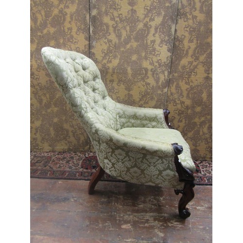 1450 - A substantial Victorian drawing room chair with buttoned back and a carved mahogany showwood frame