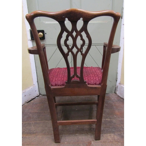 1455 - A Georgian mahogany elbow chair with pierced splat, drop in seat on square cut supports together wit... 