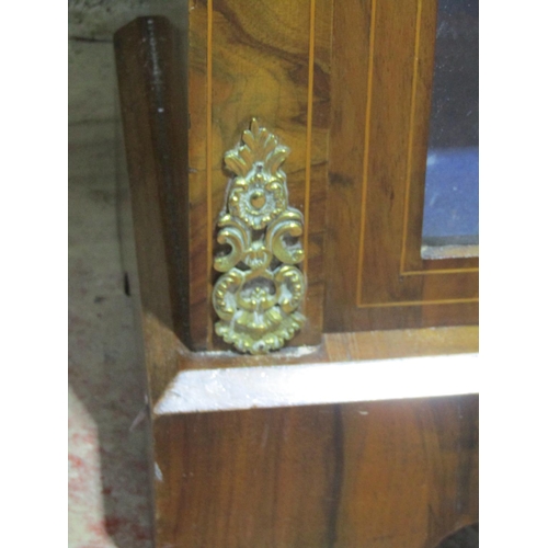 1371 - A Victorian walnut pier cabinet enclosed by a single glazed door with further brass mounts and marqu... 