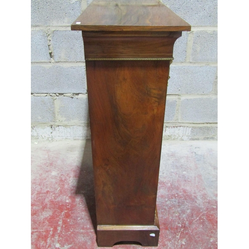 1371 - A Victorian walnut pier cabinet enclosed by a single glazed door with further brass mounts and marqu... 