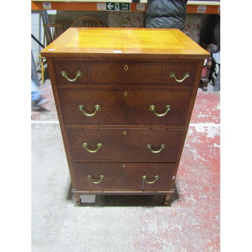 1373 - An Edwardian satin wood chest of four long graduated drawers, the top with crossbanded borders and b... 