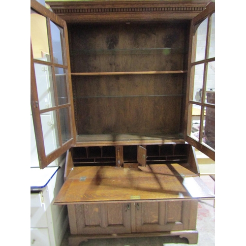 1382 - An Edwardian Oak bureau bookcase, base enclosed by 2 panelled doors, full flap enclosing a fitted in... 