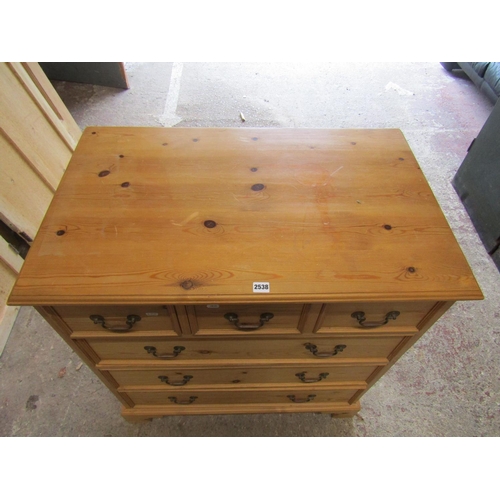 1401 - A stripped pine chest of three long and two short drawers with brass swan necked handles on bracket ... 