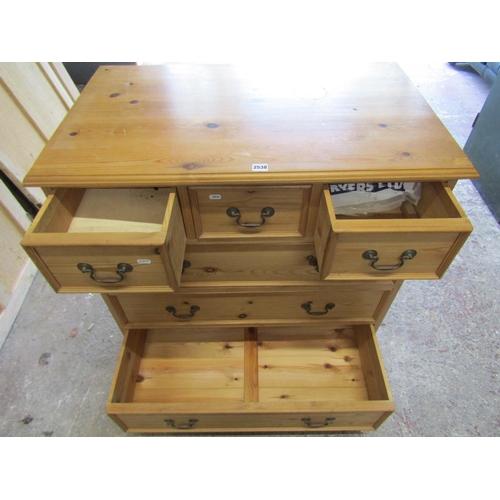 1401 - A stripped pine chest of three long and two short drawers with brass swan necked handles on bracket ... 