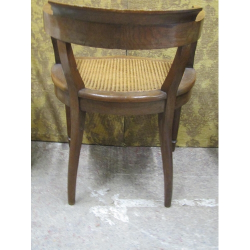 1409 - A good quality oak bergere seated office chair, together with an over-painted child’s nursery chair ... 