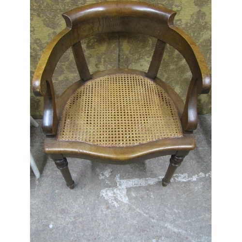 1409 - A good quality oak bergere seated office chair, together with an over-painted child’s nursery chair ... 