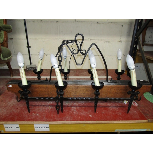 1410 - A gothic style ceiling light in oak and wrought iron bearing eight sconces, 110 cm length x 55 cm hi... 