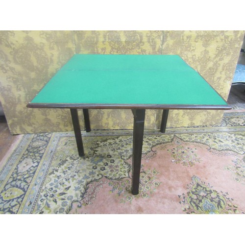 1462 - A Georgian mahogany rectangular fold over top card table, on square cut supports