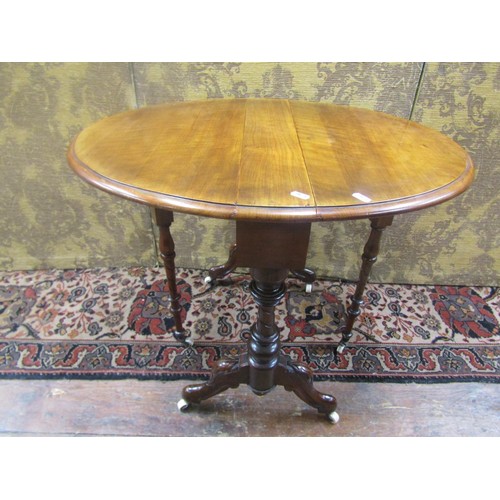 1476 - Small Victorian walnut drop leaf occasional table on turned supports, 56cm high, 55cm diameter